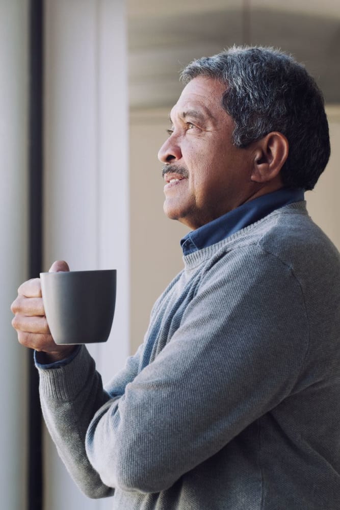 Resident enjoying a cup of coffee at Sunny Garden Apartments in La Puente, California