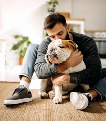 A resident holds his puppy at University Lofts at Russellville, Russellville, Arkansas