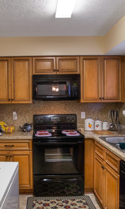 Model kitchen with large black fridge RoseHill Apartments in Columbus, Georgia