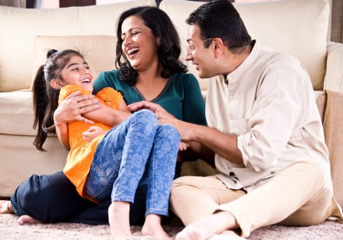 Family playing on floor at Deerfield Windsor Apartments in Windsor, Connecticut