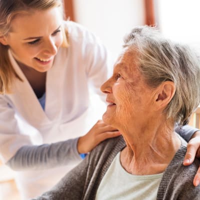 A caregiver checking in on a resident at Arbor Glen Senior Living in Lake Elmo, Minnesota