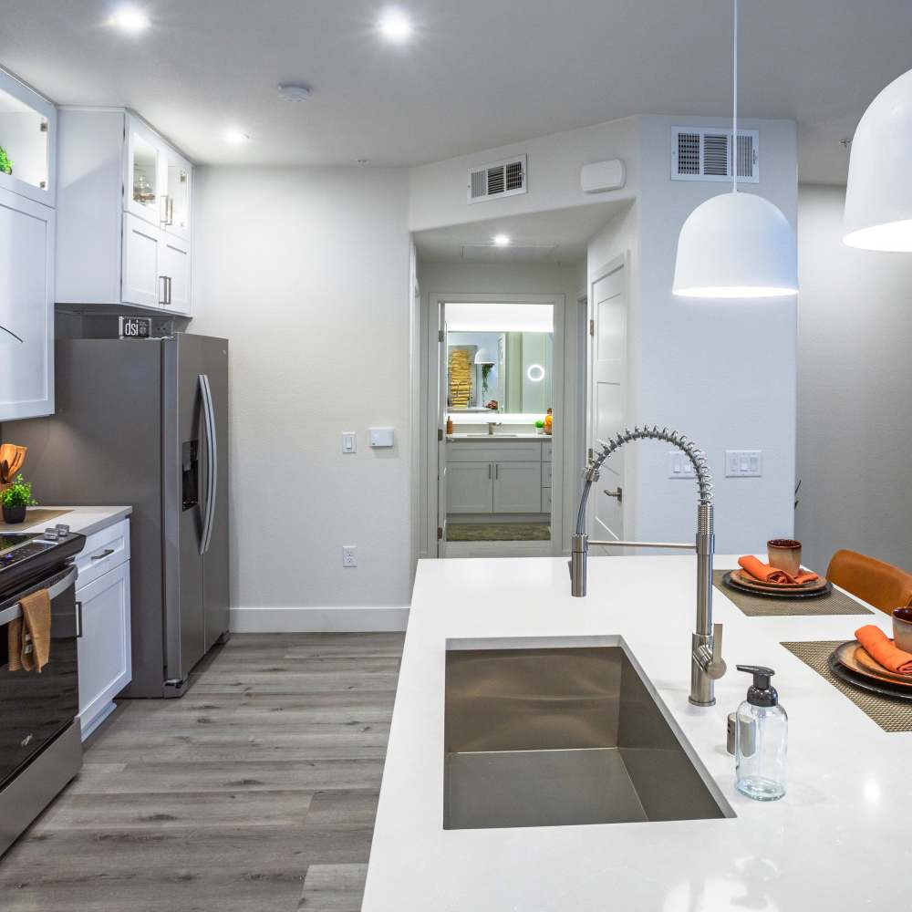 Kitchen with waterfall sink and stainless-steell appliances at Night Fall in Las Vegas. NV