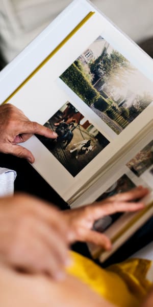 Resident looking through a scrap book at a WISH community