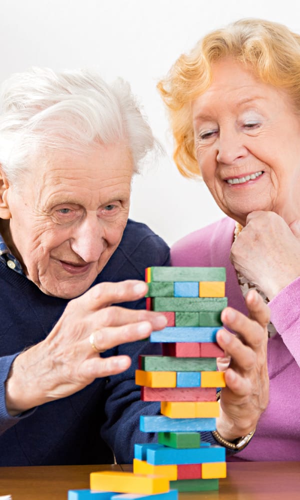 Senior couple playing jenga at The Phoenix at Estero in Estero, Florida