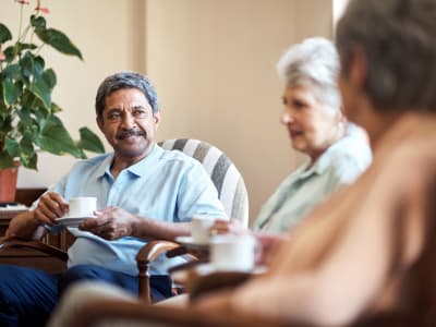 3 residents talking over breakfast at Randall Residence of Encore Village in Brighton, Michigan