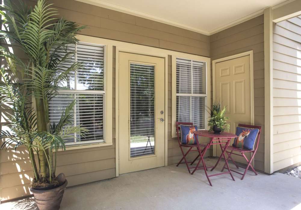 Gated table and chairs set up outside a door at Botanica in Mandeville, Louisiana