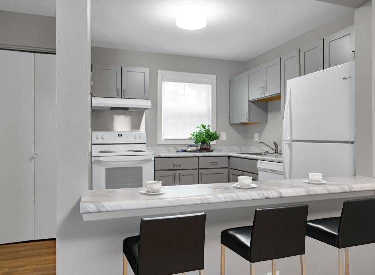 Kitchen with barstools at Powdermill Village in Westfield, Massachusetts
