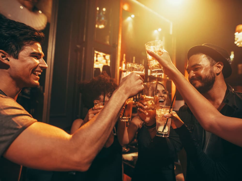 Saying cheers with some friends at a favorite neighborhood bar near The Charleston Apartments in Phoenix, Arizona