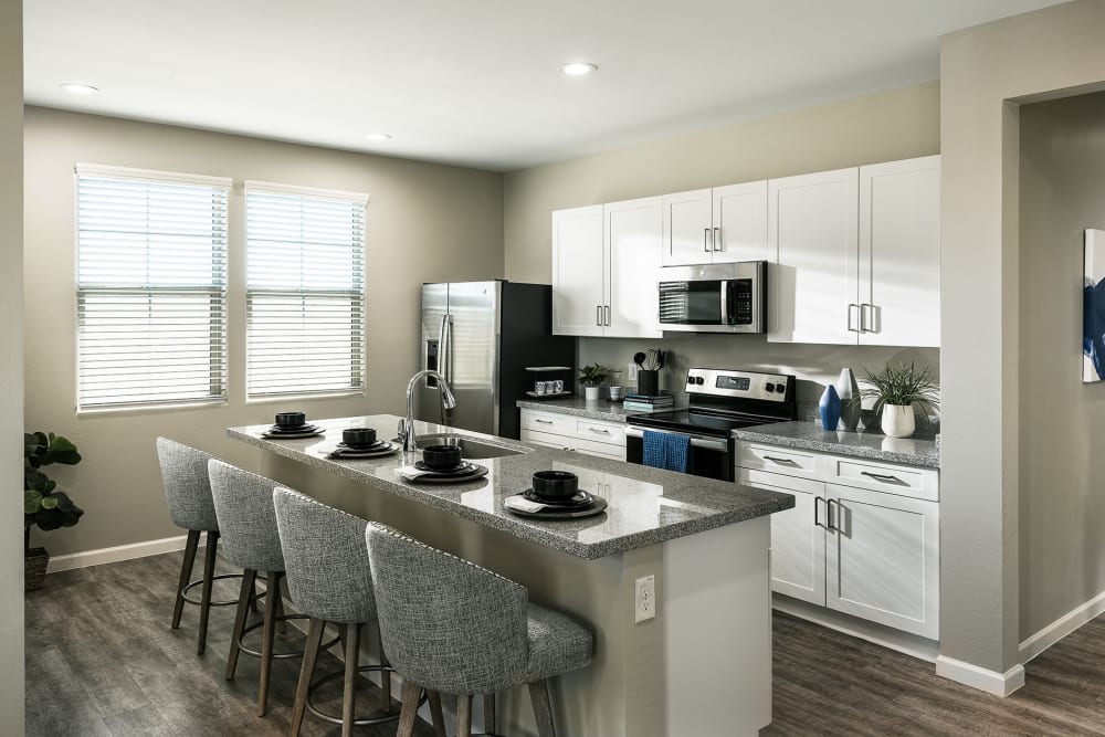 Large island in the kitchen with appliance at Las Casas at Windrose in Litchfield Park, Arizona