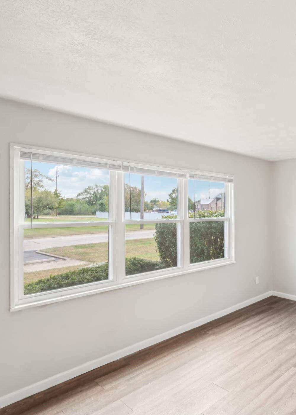 Living room with large windows at Columbus Crossing in Columbus, Indiana