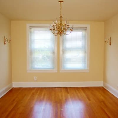 A dining room with wood flooring in a home at Perry Circle Apartments in Annapolis, Maryland