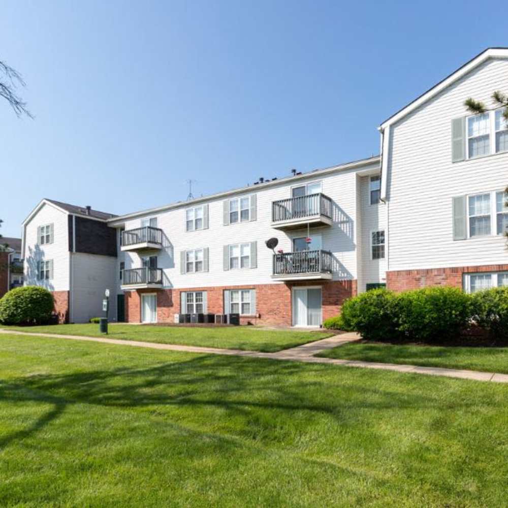 An apartments with green lawn at Village Green Apartments in Chesterfield, Missouri