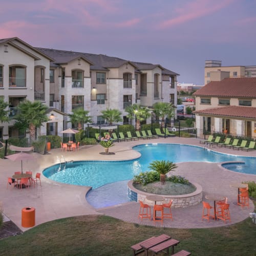 Pink sky above the pool area at sunrise at Carrington Oaks in Buda, Texas