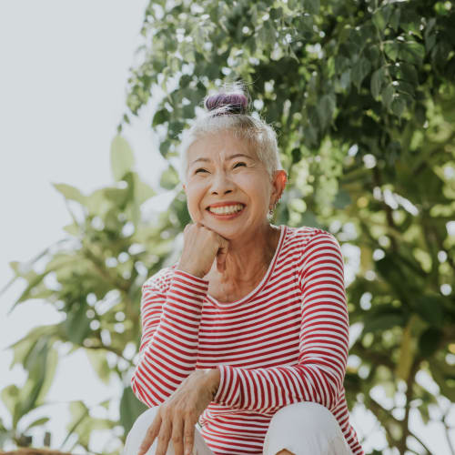 Woman posing for a photo with some trees behind here near Aspen Pines Apartment Homes in Wilder, Kentucky