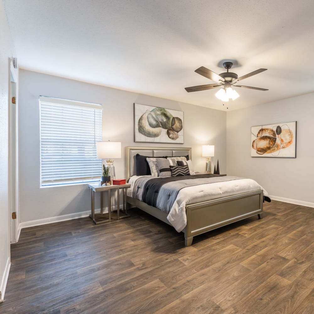 Large bedroom with wood-style flooring at The Gates in Houston, Texas