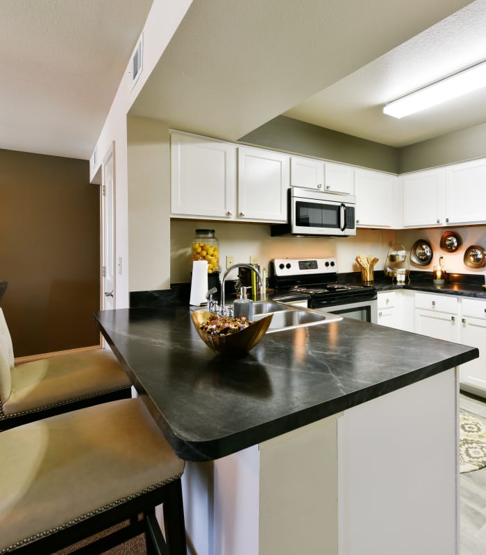 Kitchen with granite countertops at Cottages at Abbey Glen Apartments in Lubbock, Texas