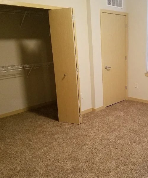 Bedroom with walk-in closet at Mill Creek Apartments in Cross Plains, Wisconsin