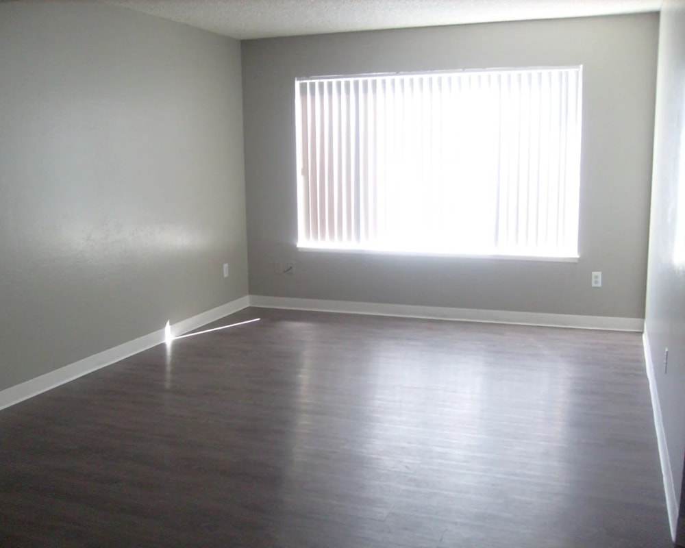 Living room with wood-style flooring at Park Place Apartments in Roseville, California