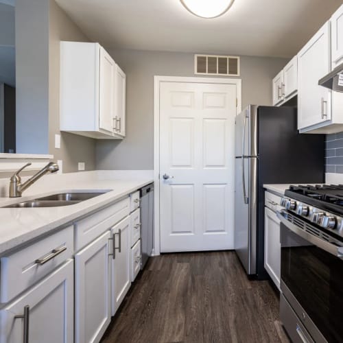 Apartment kitchen with stainless-steel appliances at Orchard Village in Aurora, Illinois
