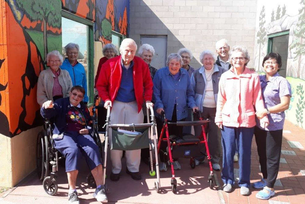 Group of residents gathered on a sunny day at HeatherWood Assisted Living & Memory Care in Eau Claire, Wisconsin