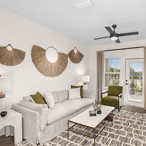 A furnished living room in an apartment model home at The Baldwin in Orlando, Florida