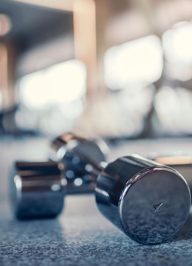 Resident working out at the fitness center at Palm Lake Apartment Homes in Concord, California