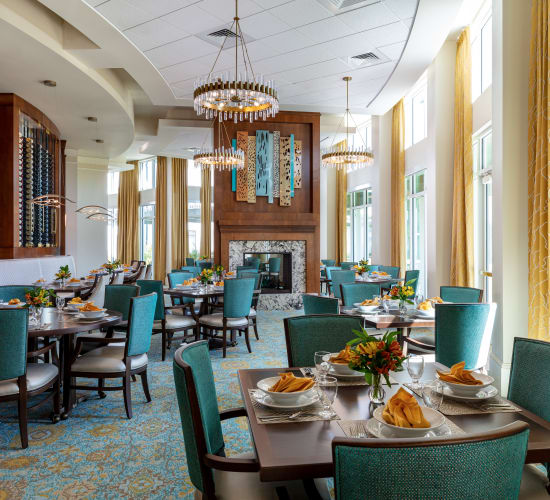 Dining room and a fireplace at Amira Choice Sarasota in Sarasota, Florida. 