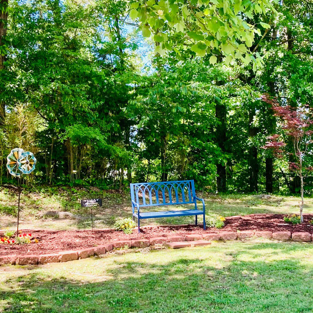 Sitting chair in the lush landscape at Cannongate Apartments in Vicksburg, Mississippi