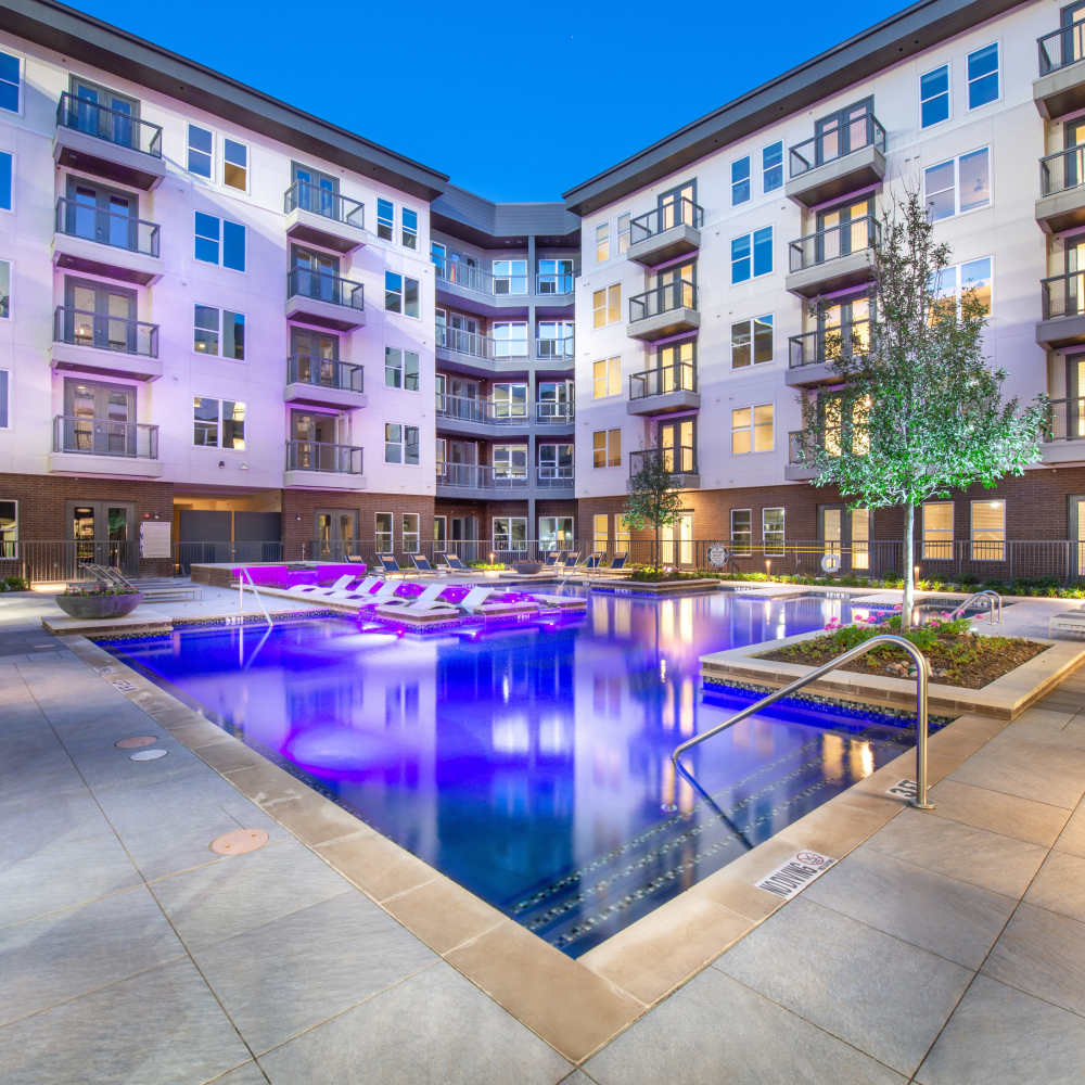Resort-style swimming pool in the evening view at Hall Street Flats in Dallas, Texas