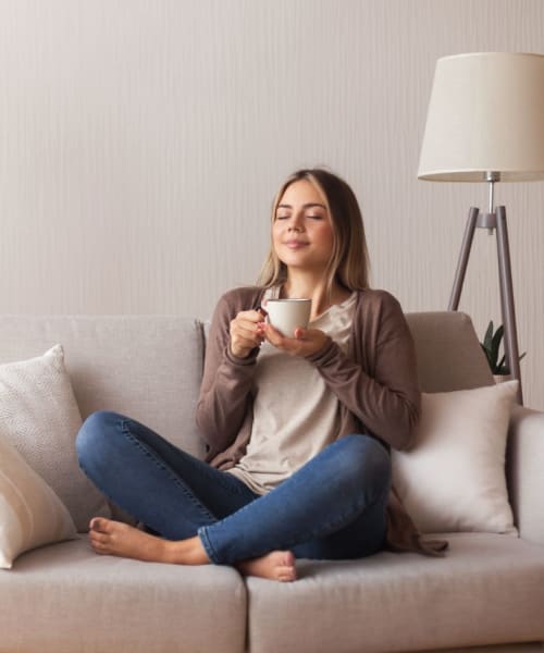 Resident relaxing in her apartment at The 603 in Bryan, Texas