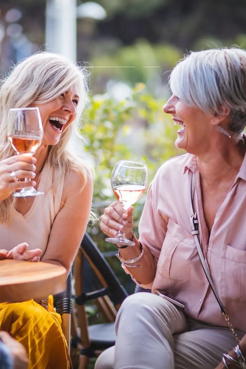 Resident sharing a glass of wine at Carriage Inn Katy in Katy, Texas