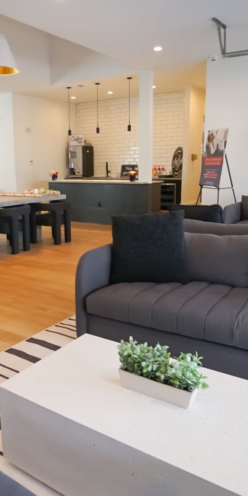Coffee bar and couches in the clubhouse at The Leonard in Denton, Texas