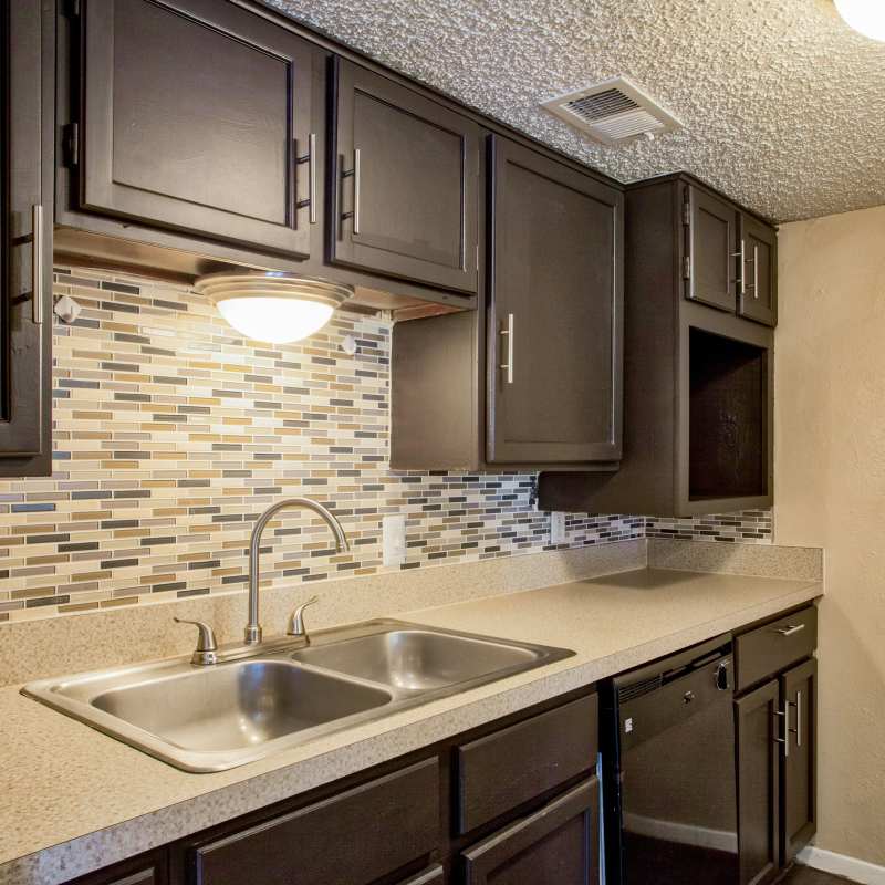 Apartment kitchen with cabinetry at Highlands Creek Apartments in Dallas, Texas