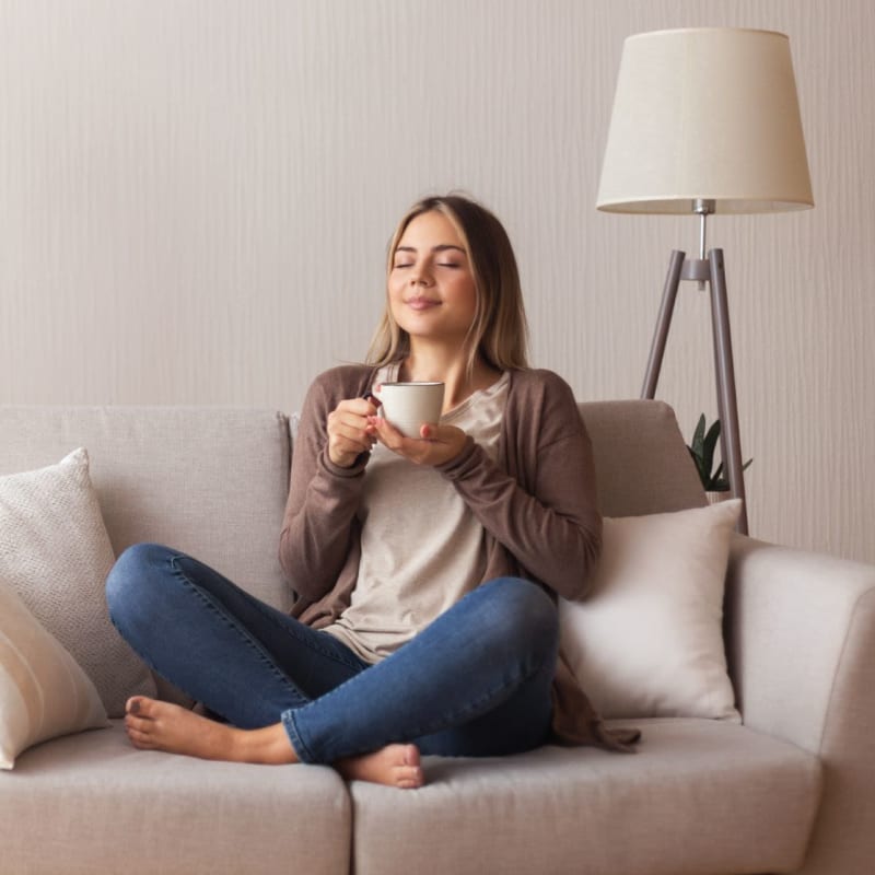 Resident relaxing with a cup of tea at Villas Del Lago in Los Angeles, California