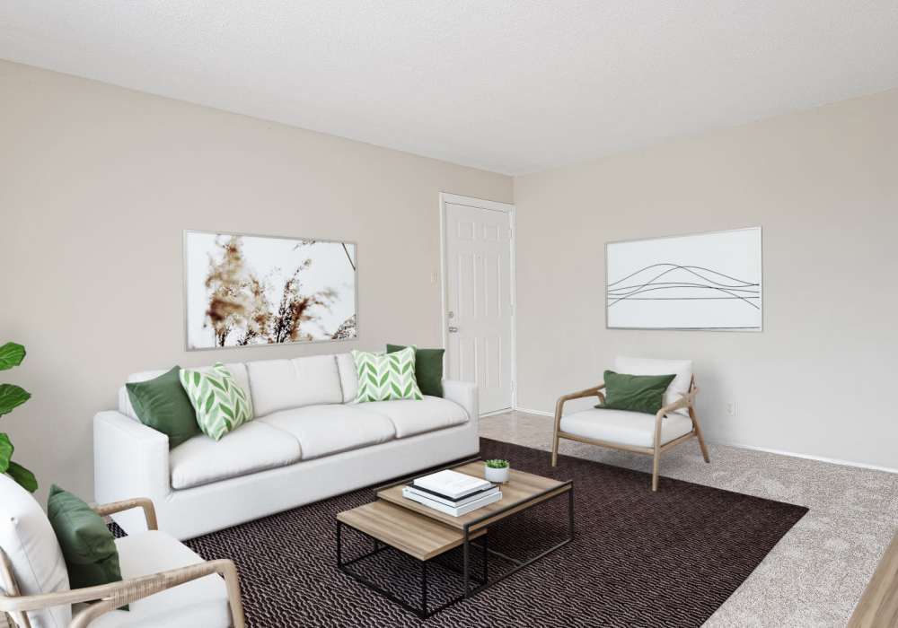Spacious living room with large couch, chairs and coffee table at Courtyard Apartments in Columbia, Missouri