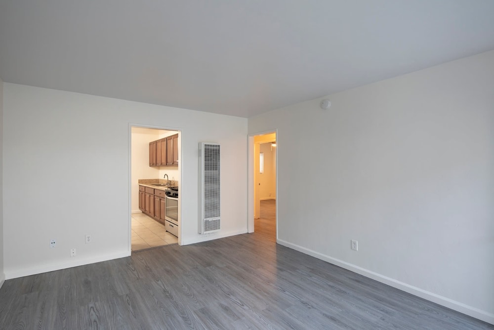 Spacious living space leading to kitchen at Ocean Palms Apartments in San Diego, California