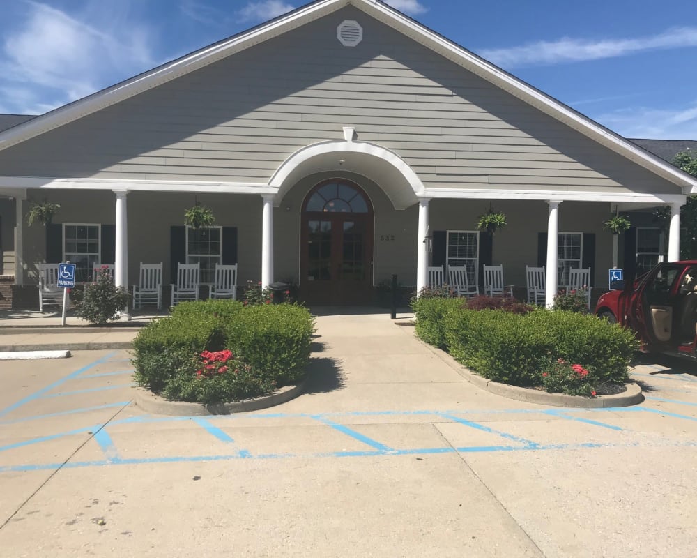 View of main entrance and covered porch with rocking chairs at Arcadian Cove in Richmond, Kentucky.