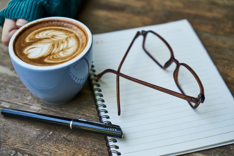 Cup of coffee and a notebook on a table at S & S Property Management in Nashville, Tennessee