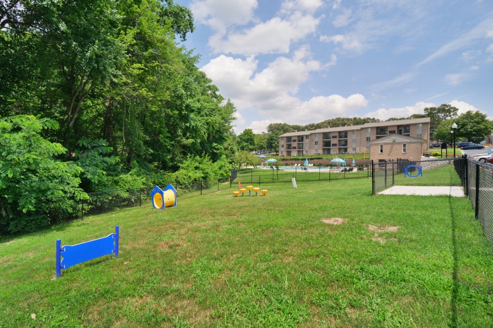 Fenced dog park with agility equipment at Quail Hollow Apartment Homes in Glen Burnie, Maryland