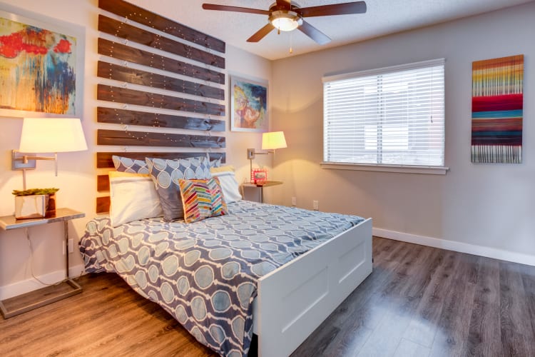 Well-decorated master bedroom with a ceiling fan in a model home at Array Apartments in Austin, Texas