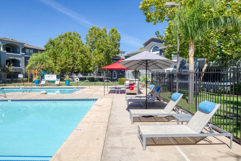 Swimming pool with lounge chairs at The Lofts in Sacramento, California
