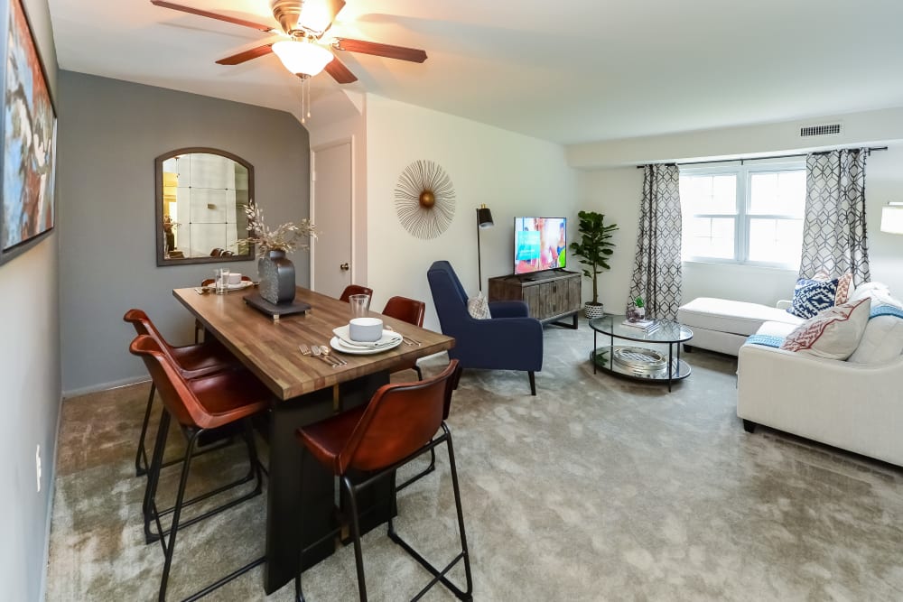 Dining area and living room of a model home at Forge Gate Apartment Homes in Lansdale, Pennsylvania