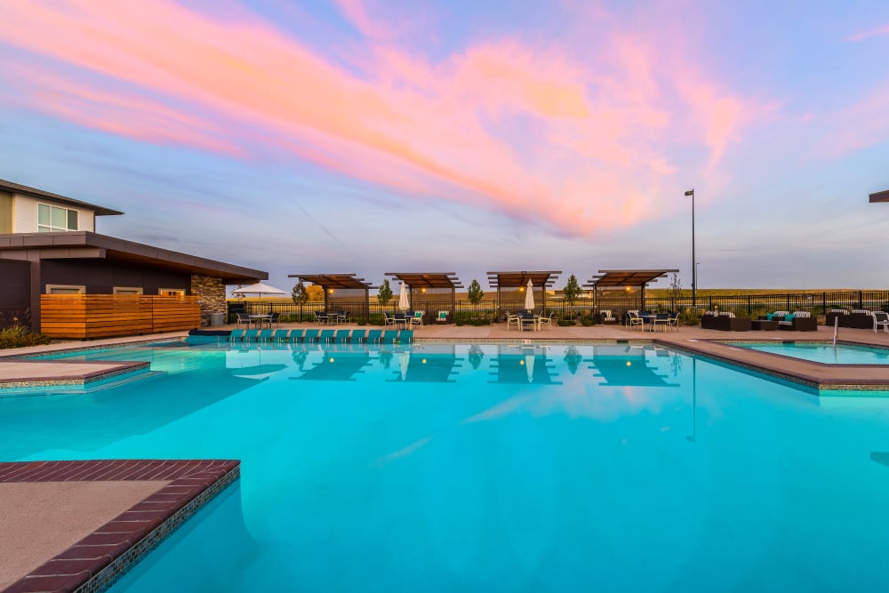 Community swimming pool at Strata Apartments during a beautiful Colorado sunset
