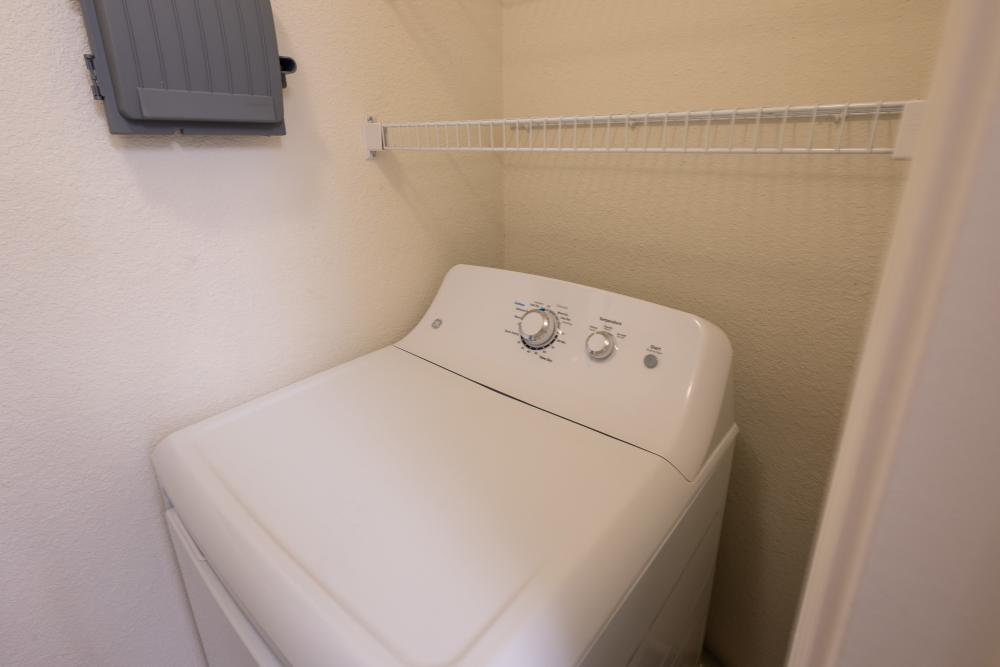 Cozy laundry nook featuring a modern washing machine for your convenience at Adobe Ranch in Borger, Texas.
