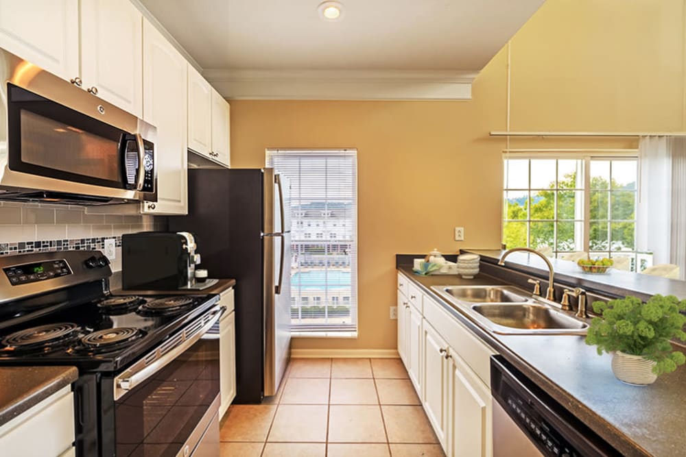 Model kitchen with white cabinetry and stainless-steel appliances 