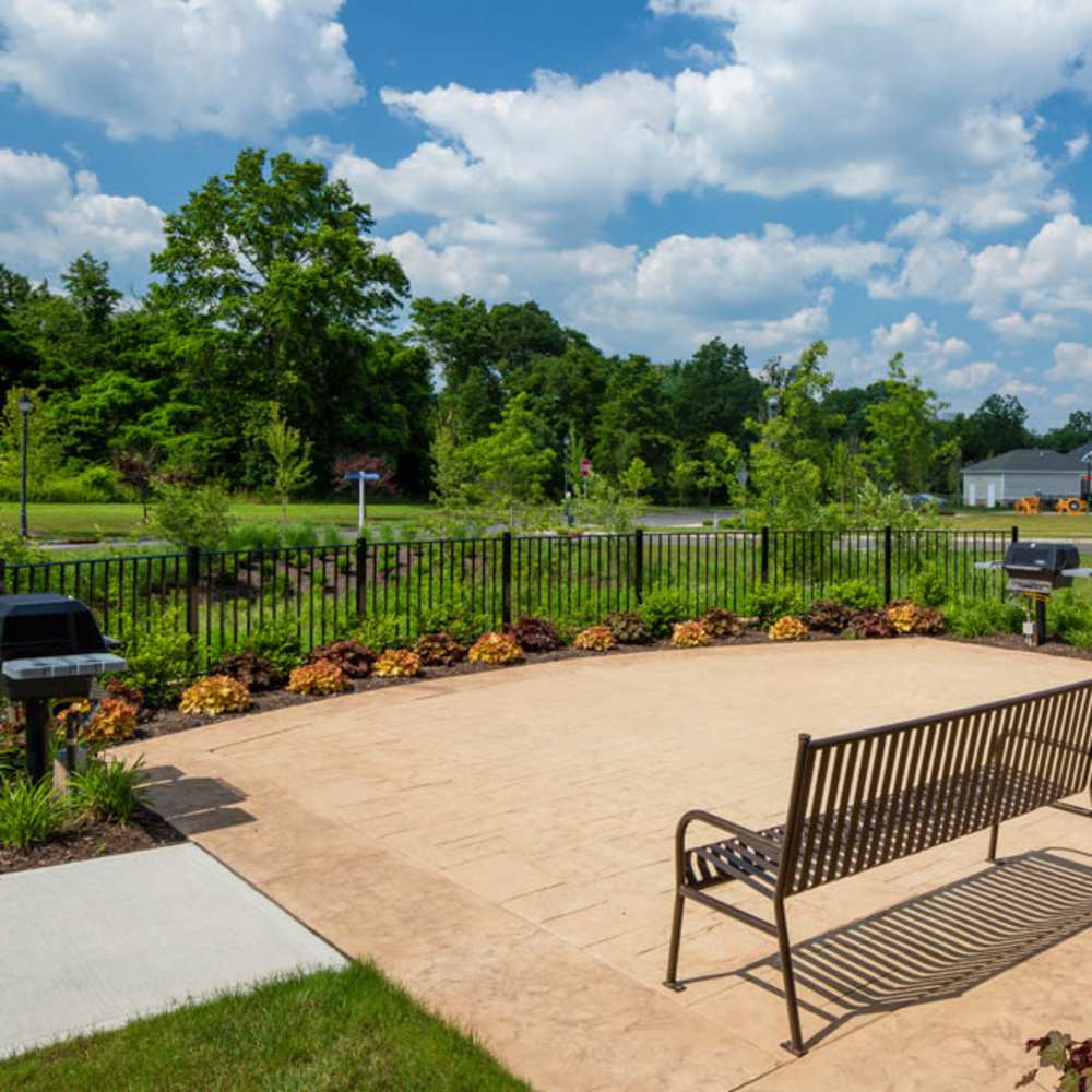 Outdoor grill area with seating at Grove at Somerset in Somerset, New Jersey