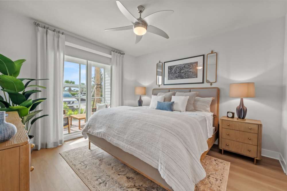 Bright bedroom with balcony access at Coconut Pointe in Estero, Florida