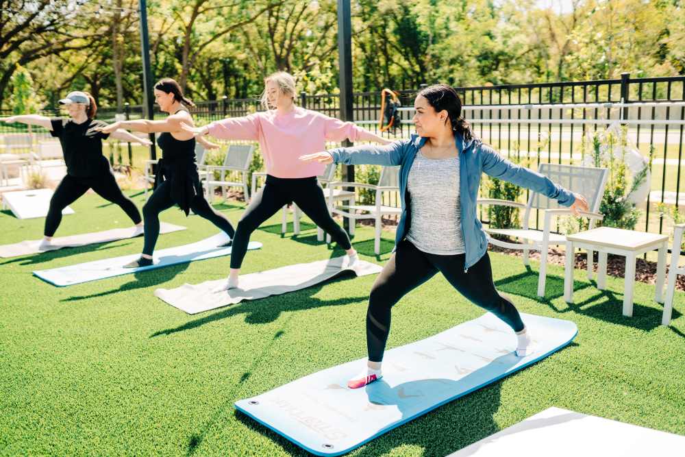 Residents doing yoga at The Waters at Promenade in Marrero, Louisiana