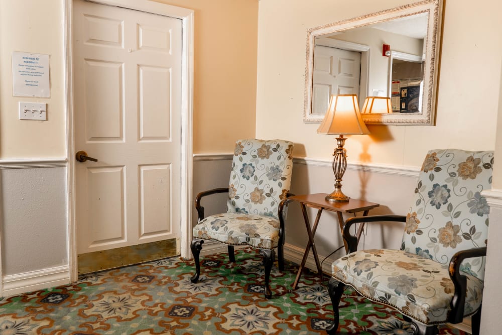 Wide hallways with carpetn and comfortable seating at The Club at Lake Wales in Lake Wales, Florida