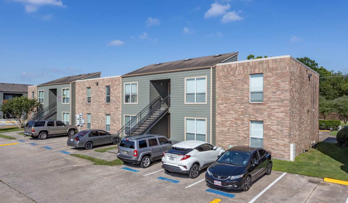 Exterior shot of apartments with off-street parking at University Green Apartments in Houston, Texas